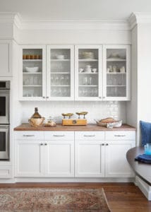 glass front white cabinets butcher block counter