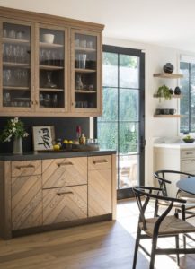 wood chevron kitchen cabinets with dark countertop