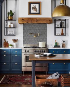 blue kitchen cabinets and tiled stove backsplash in an eclectic kitchen