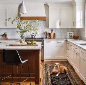 white kitchen cabinets with wood island and vintage runner