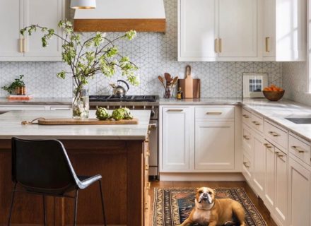 white kitchen cabinets with wood island and vintage runner