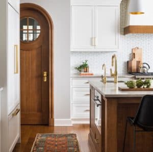 wooden arched door in white kitchen