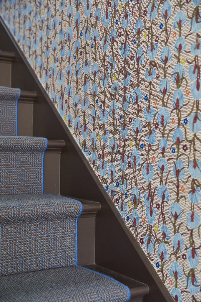 blue patterned wallpaper with stair runner